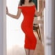 Linda -Asiatisches Escort Frankfurt im engen roten Kleid in einem Türrahmen stehend.